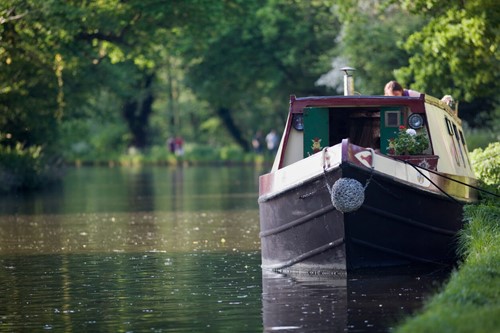 narrowboat moored up against a grassy bank